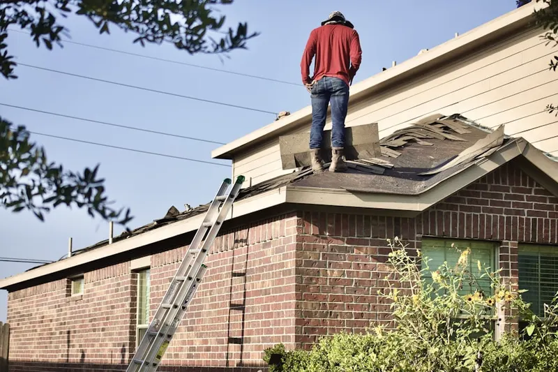 Professional roofer working on a residential roof in Rusch Park